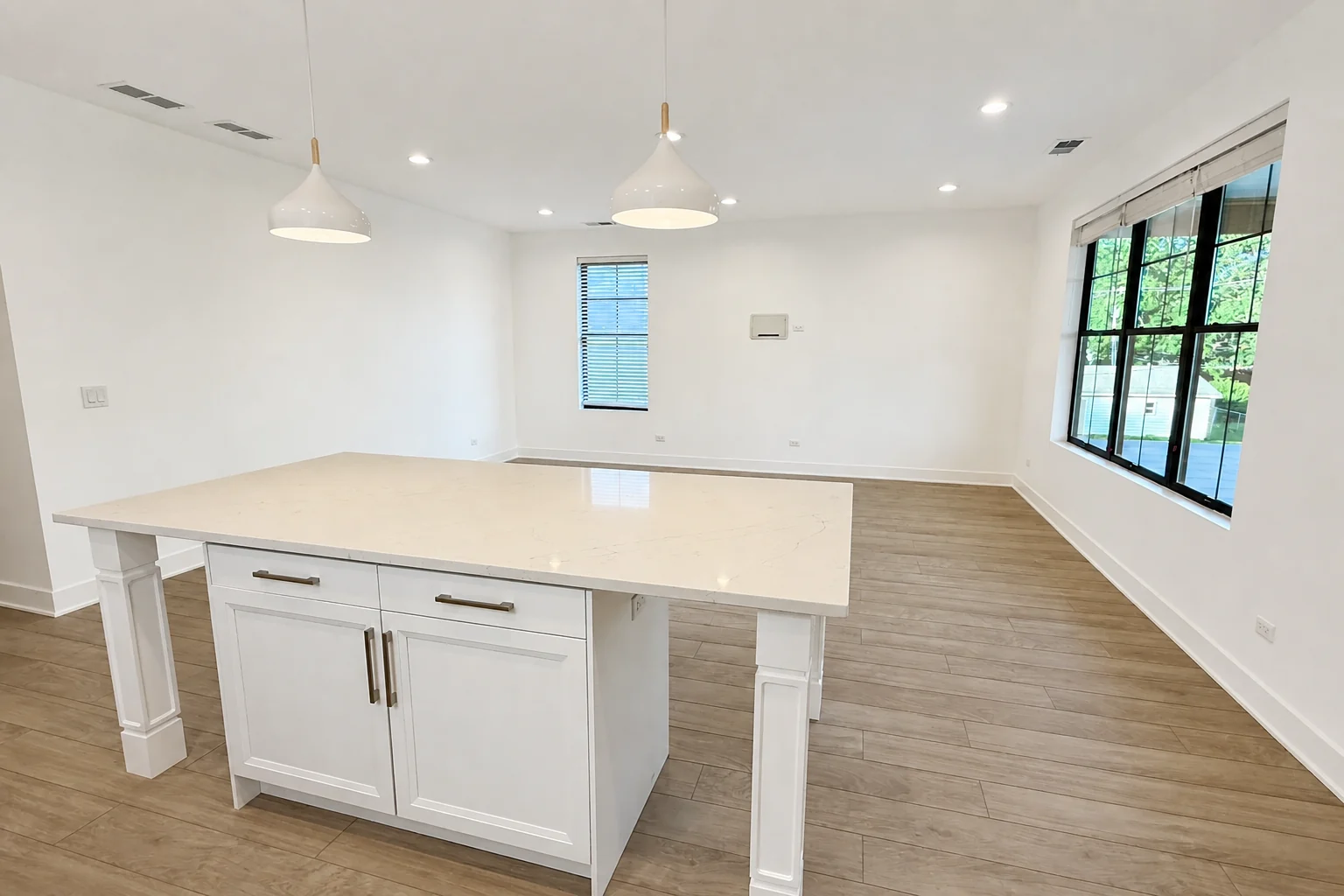 Open-concept great room with kitchen island and large windows at West Street Homes in Naperville