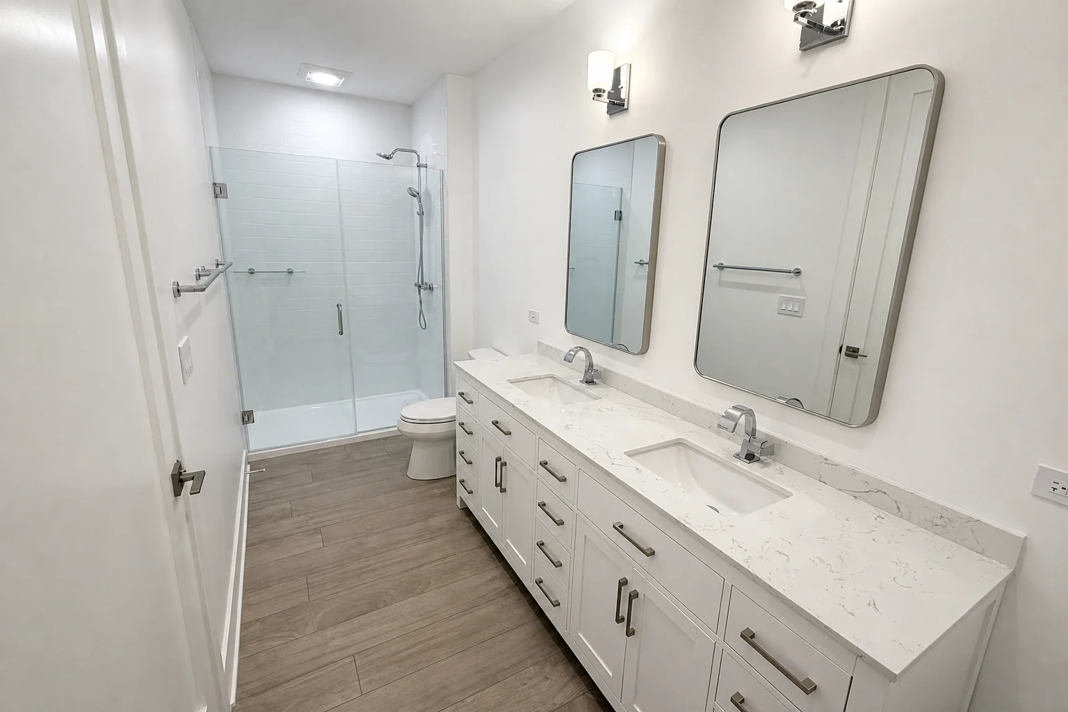 Primary bathroom with dual vanity and walk-in glass shower at West Street Homes in Naperville